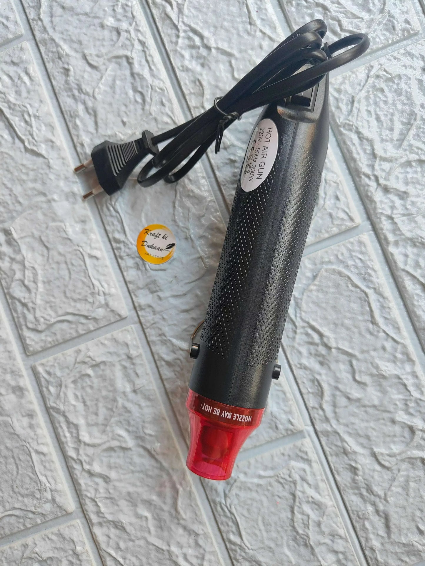 Heat tool with black cord and red transparent barrel end