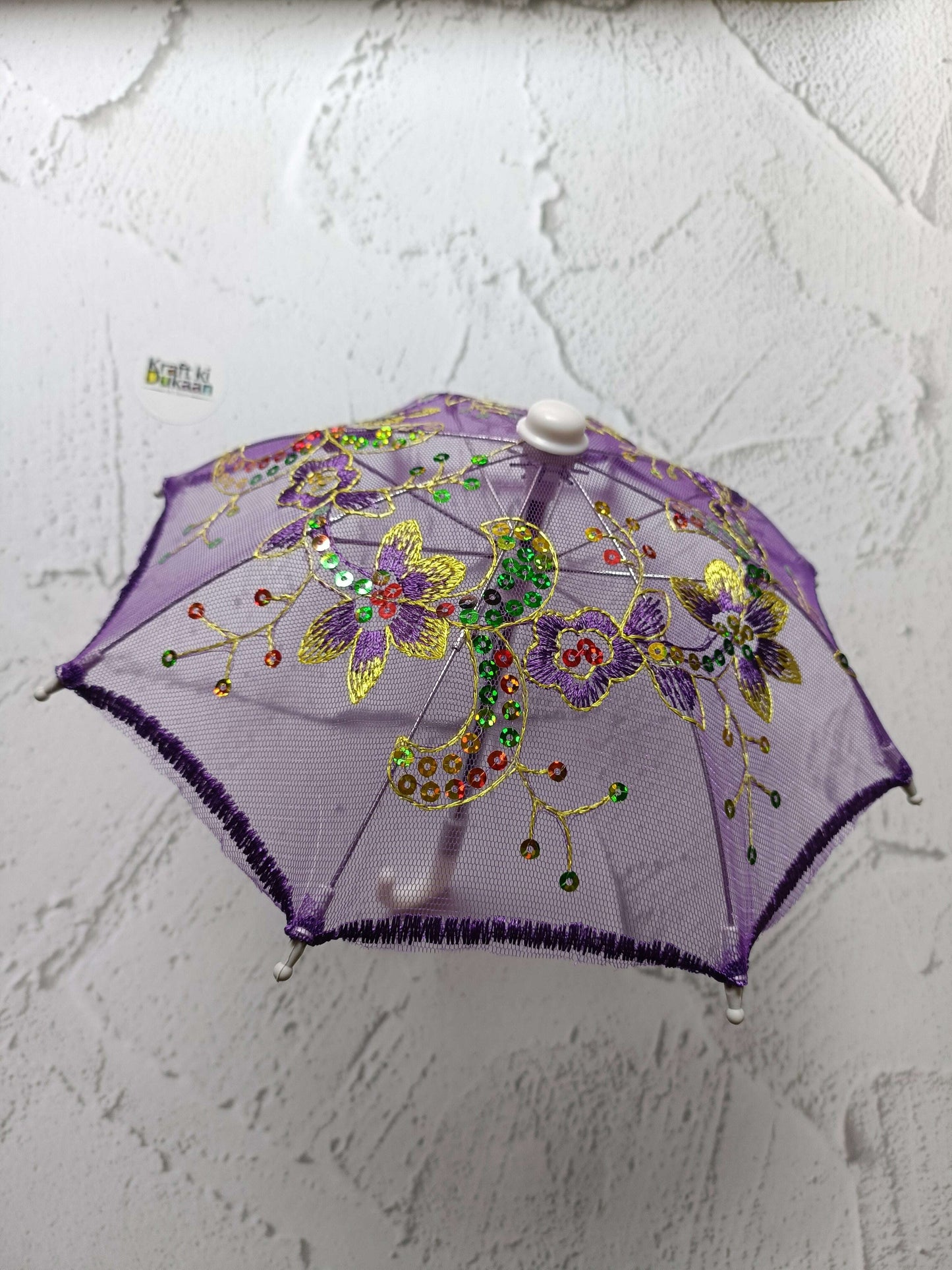 Purple decorative umbrella with floral beaded design and round top cap