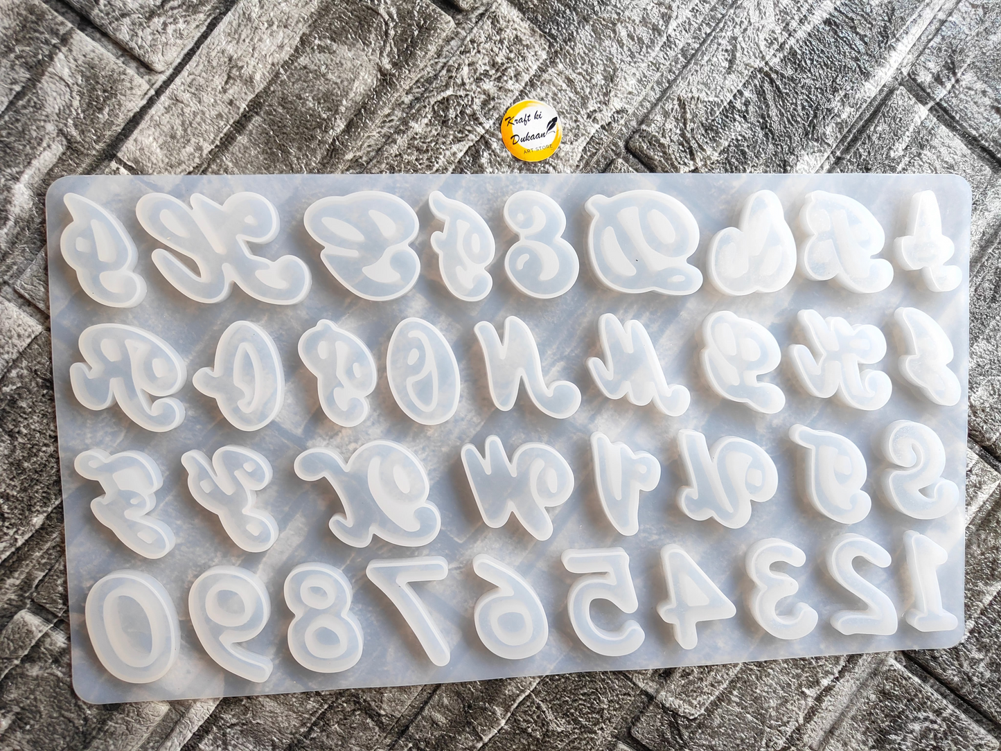 Cursive alphabet mold for resin by Kraft ki Dukaan with all letters and numbers in white silicone