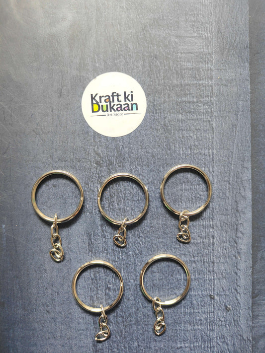 Silver round keychain rings with small chain hooks, hanging charm details