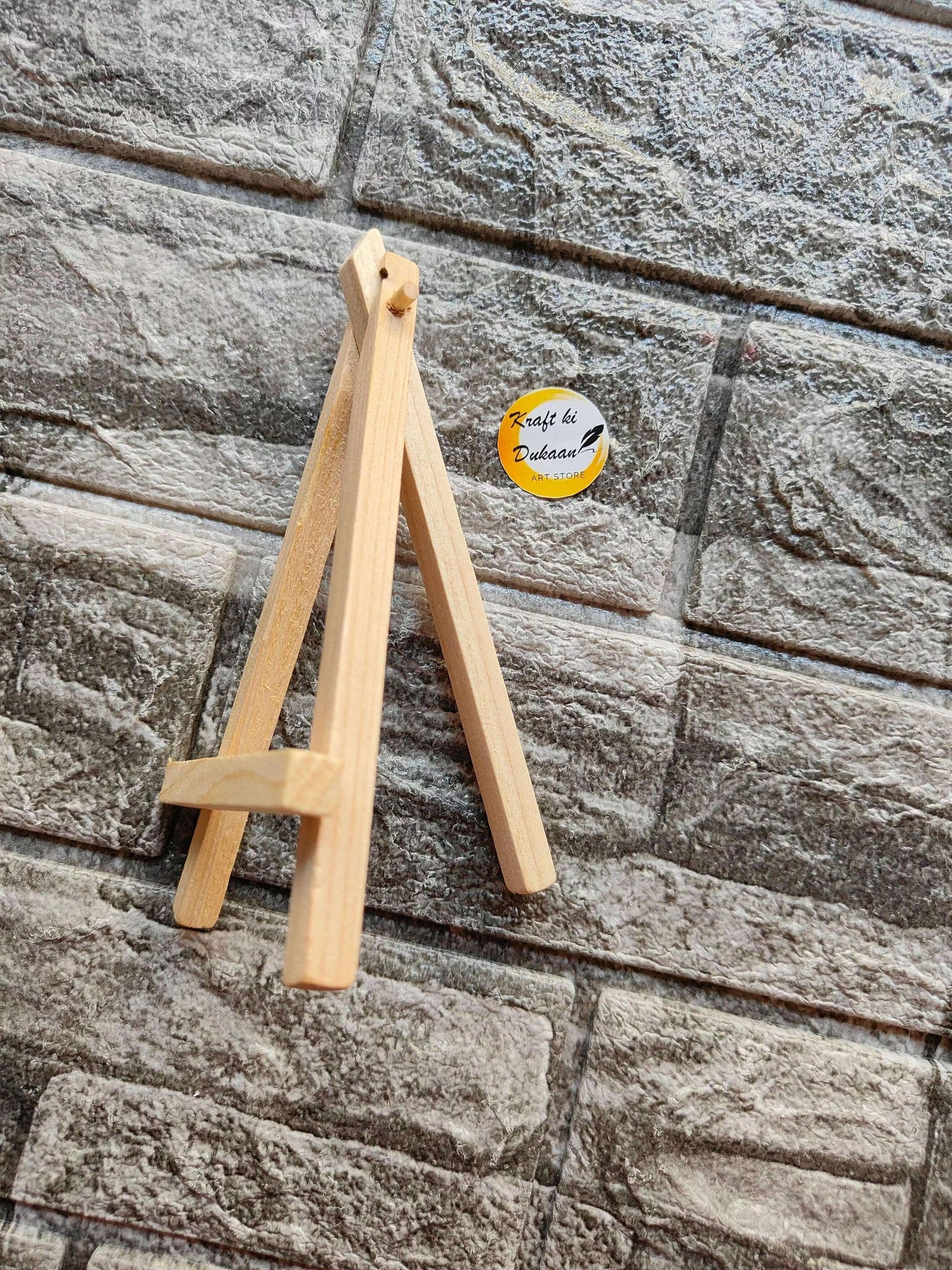 Wooden easel stand angled view, showing A-frame legs and cross support