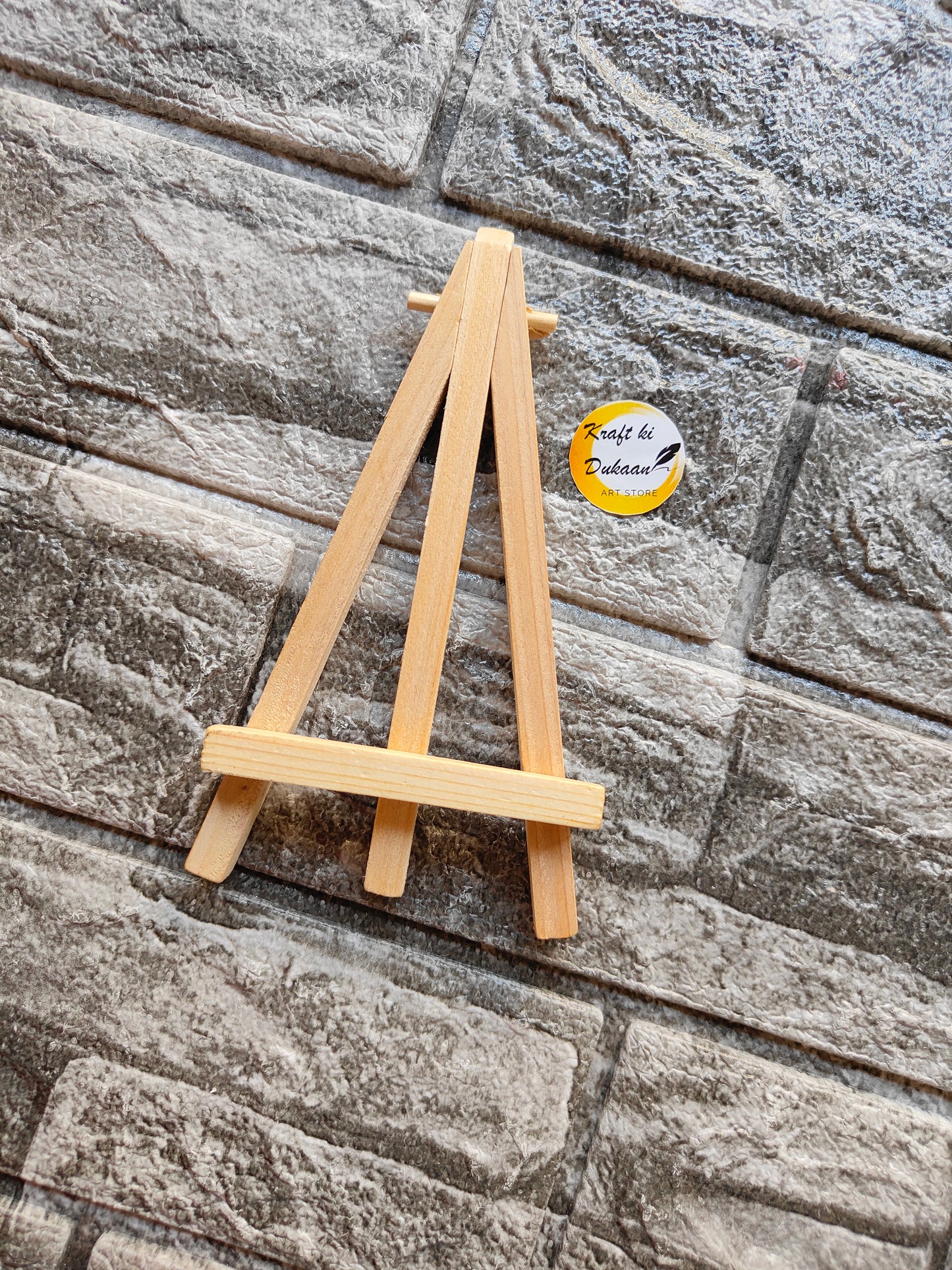 7 inch wooden easel stand from Kraft ki Dukaan on textured gray stone background