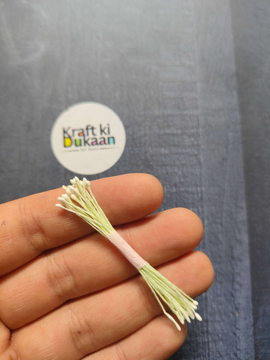 Artificial Pollens 6CM bunch—white/cream petals on pale green stems in hand.