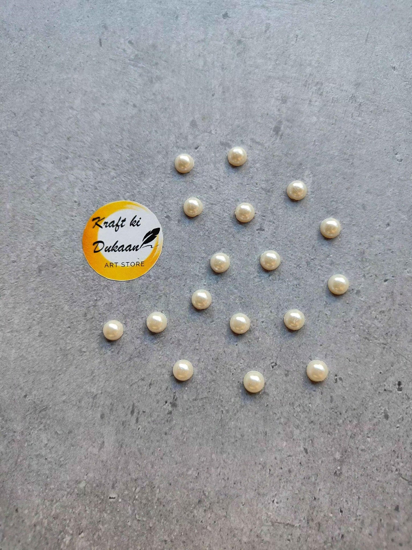 Cream pearl half-cut round beads in small cream-toned round pieces