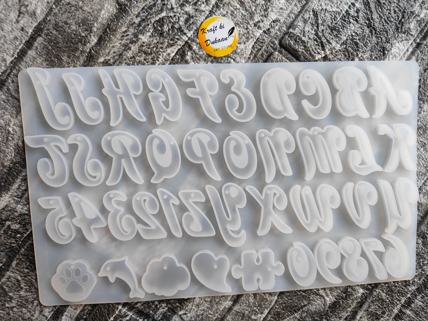 Kraft ki Dukaan cursive alphabet mold for resin with lowercase letters and symbols on gray background
