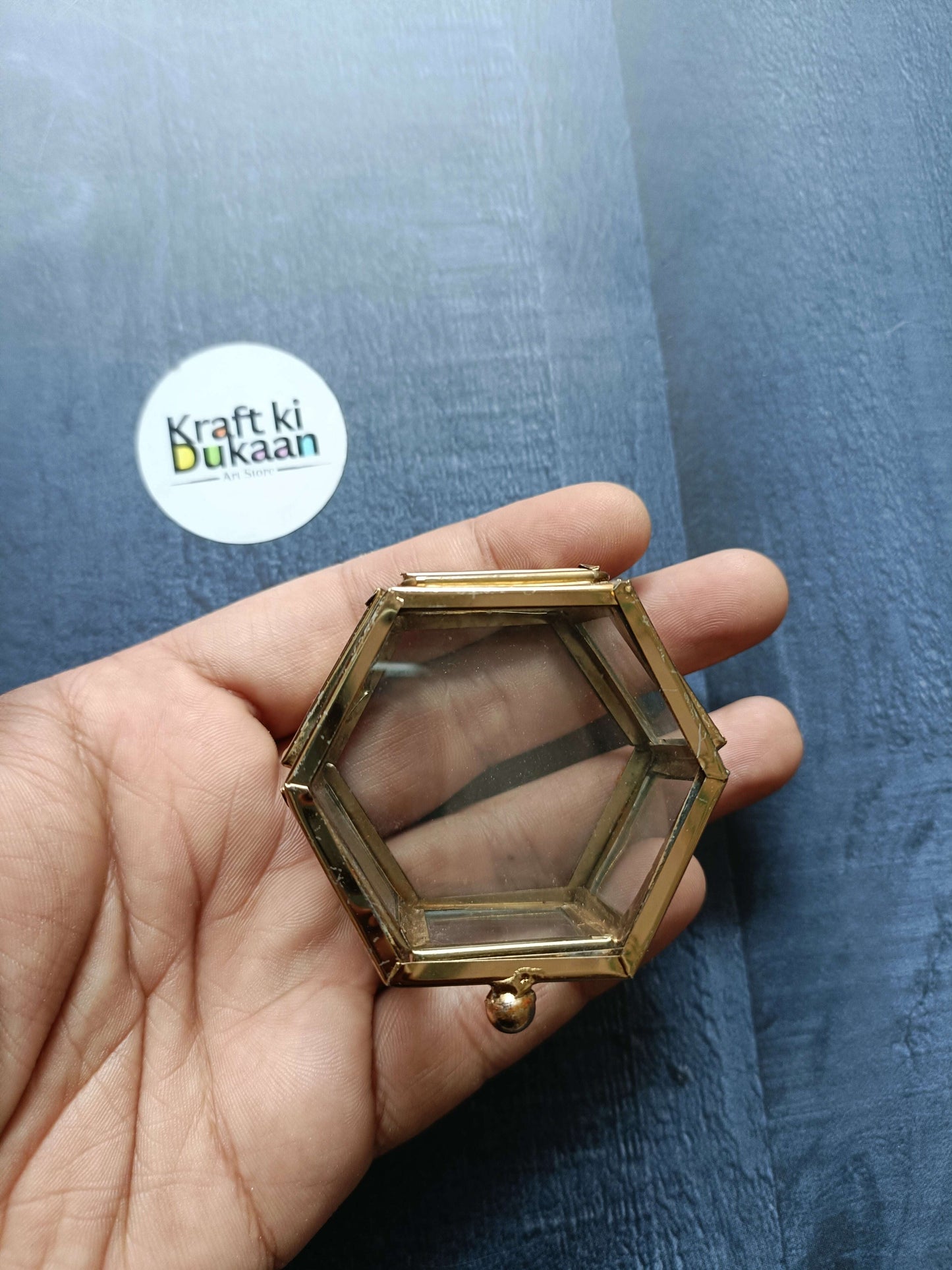 Brass hexagon glass box close-up, hinged lid and round knob