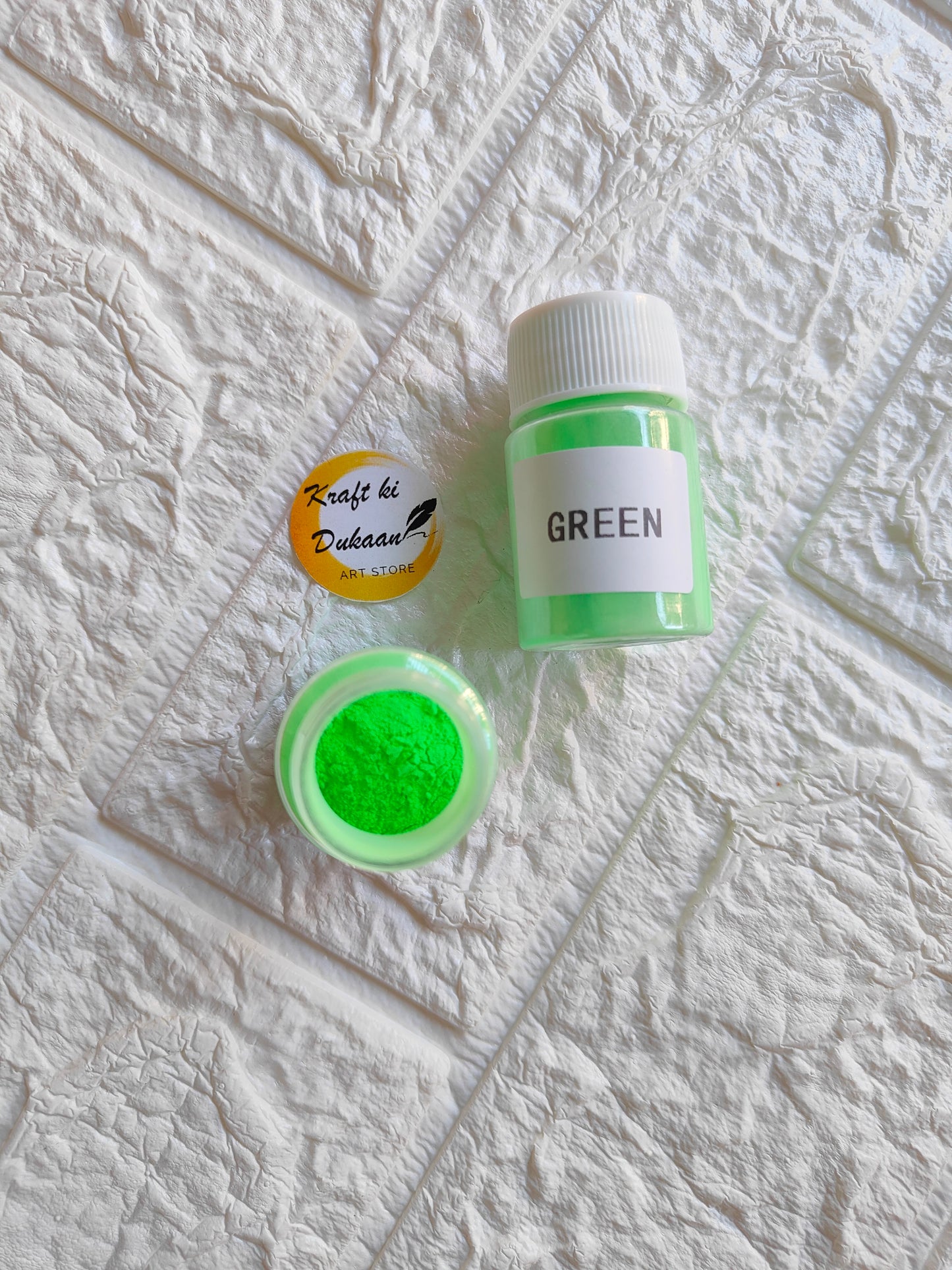 Green glow mica powder for resin in a clear container by Kraft ki Dukaan, perfect for crafts and art projects