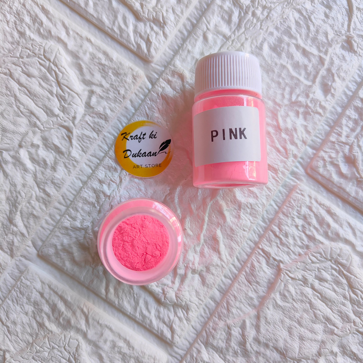Pink Glow Mica Powder for Resin in a clear container for crafting and art projects