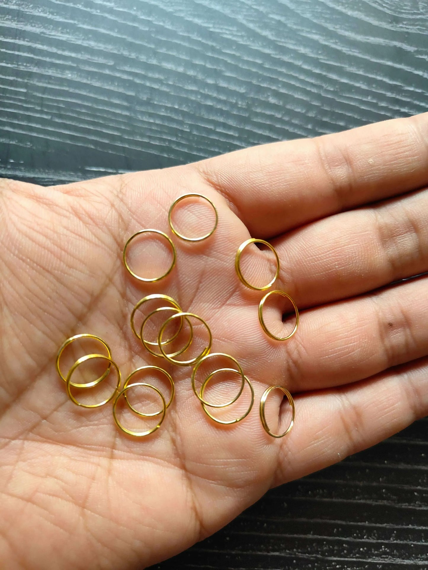 Golden Circle metal rings, gold-tone ring loops spaced out on palm surface
