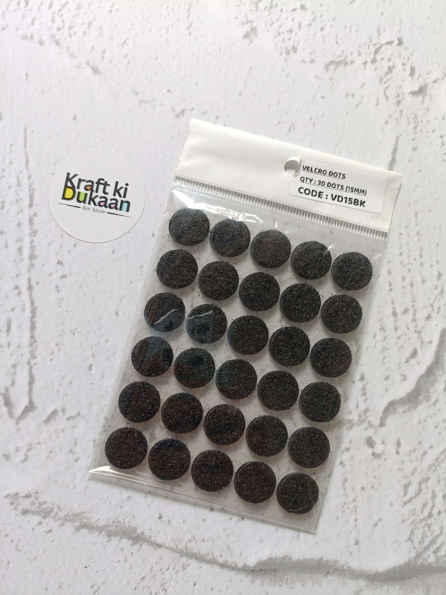 Black round Velcro dots set on backing card in clear sealed pack
