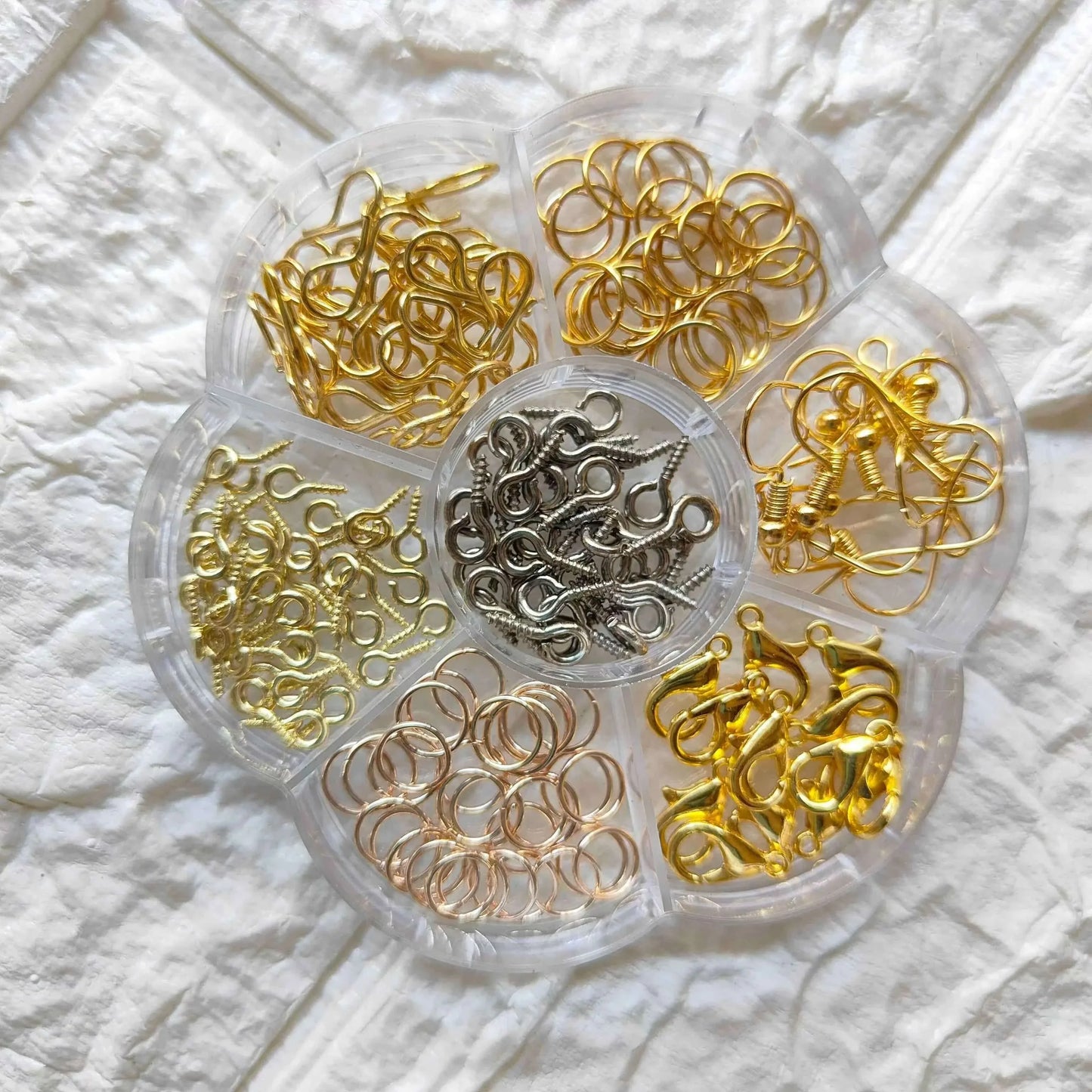 Clear hook organizer tray with gold, silver, and black metal hook loops