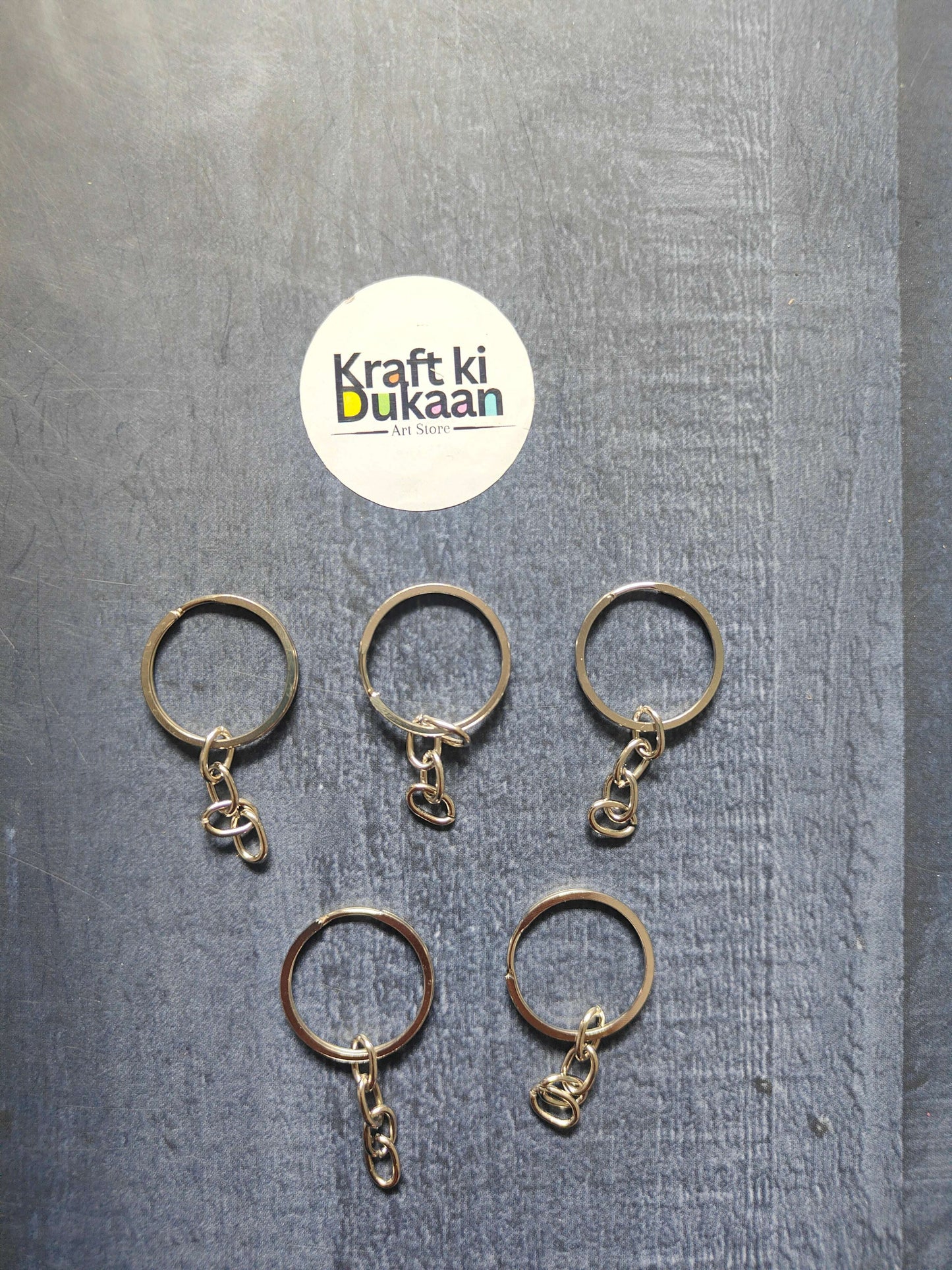 Set of small metal keychain rings with short chain links, assorted tones
