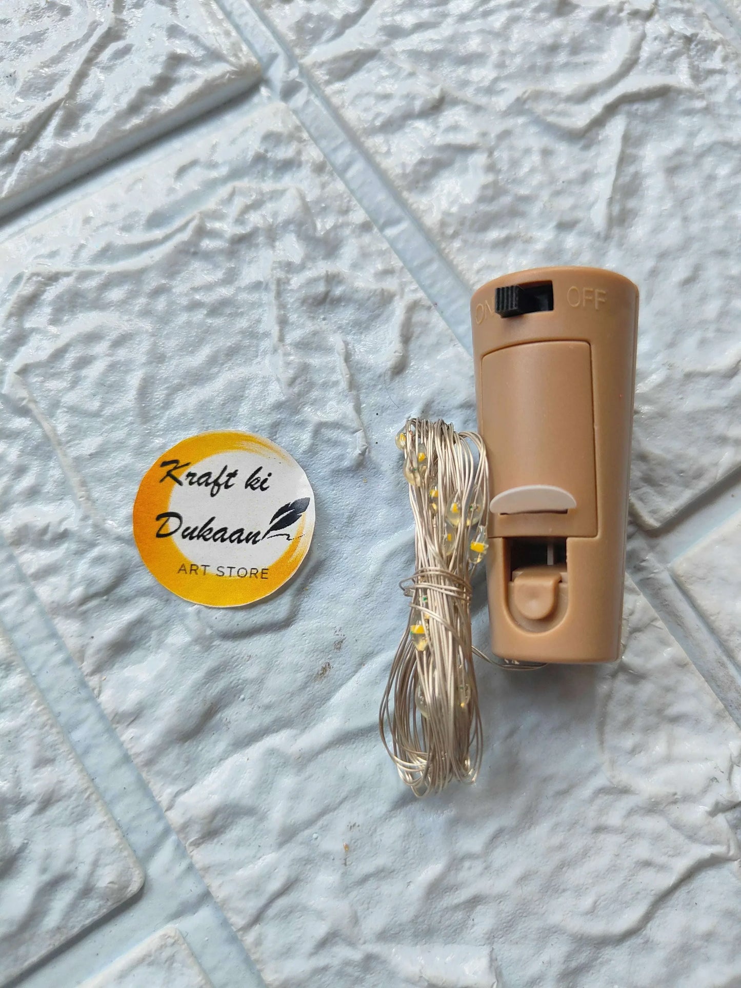 Light yellow LED candle lamp base with ON/OFF slider and clear wire bundle