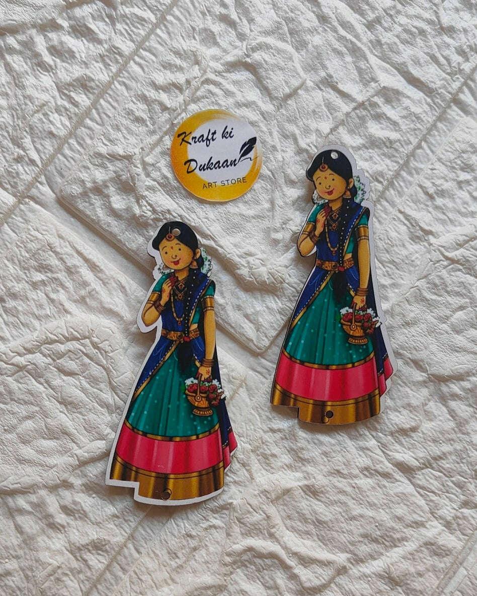 MDF cutout: two girl figures in green and red traditional dress, circular logo