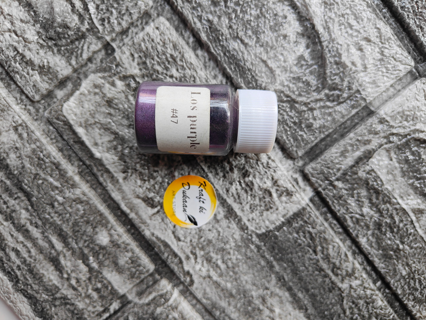 Kraft ki Dukaan purple mica powder for resin art in a small container on a textured surface