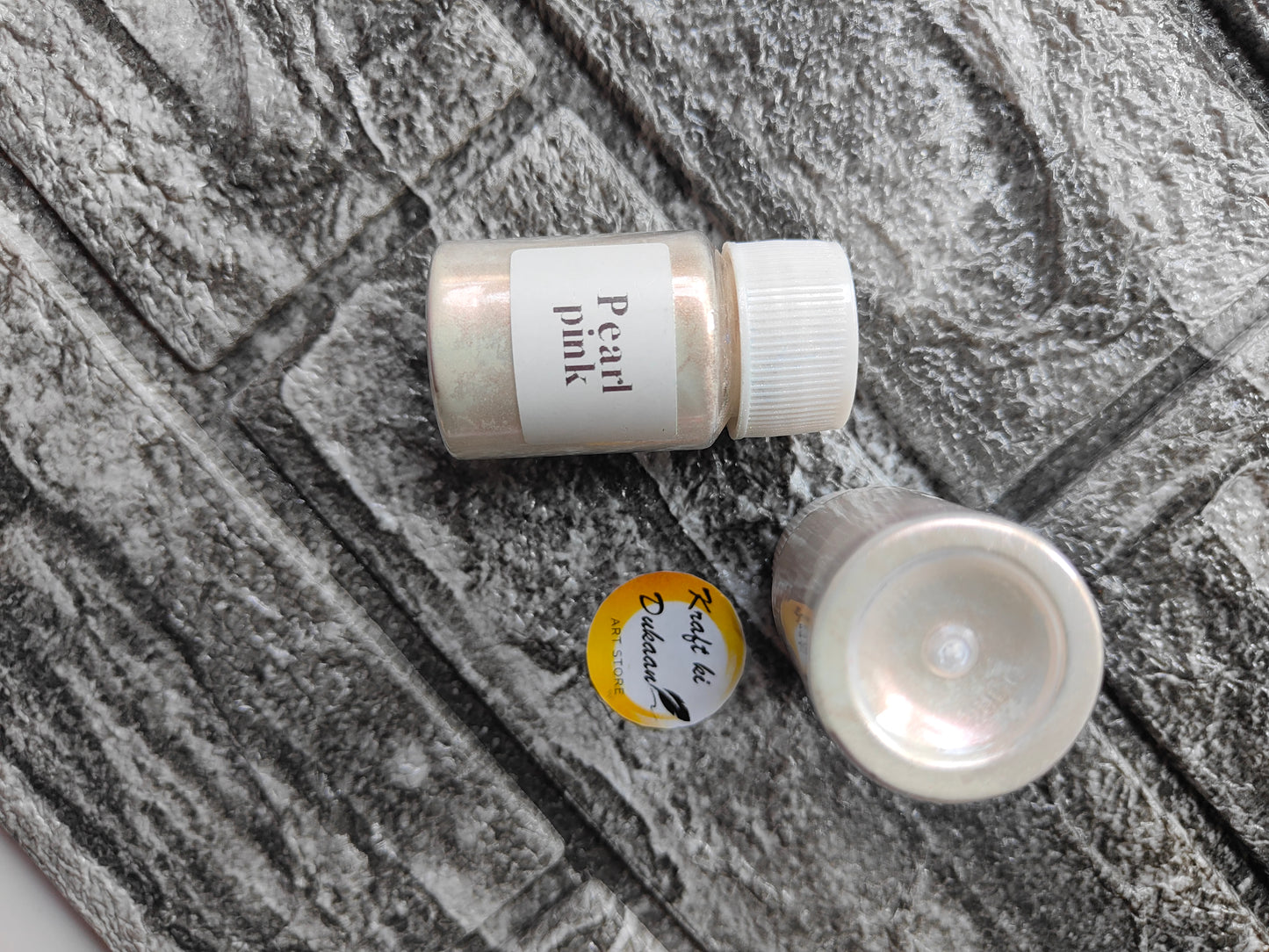 Kraft ki Dukaan Pearl Pink Mica Powder for Resin Art in a small jar on a textured surface