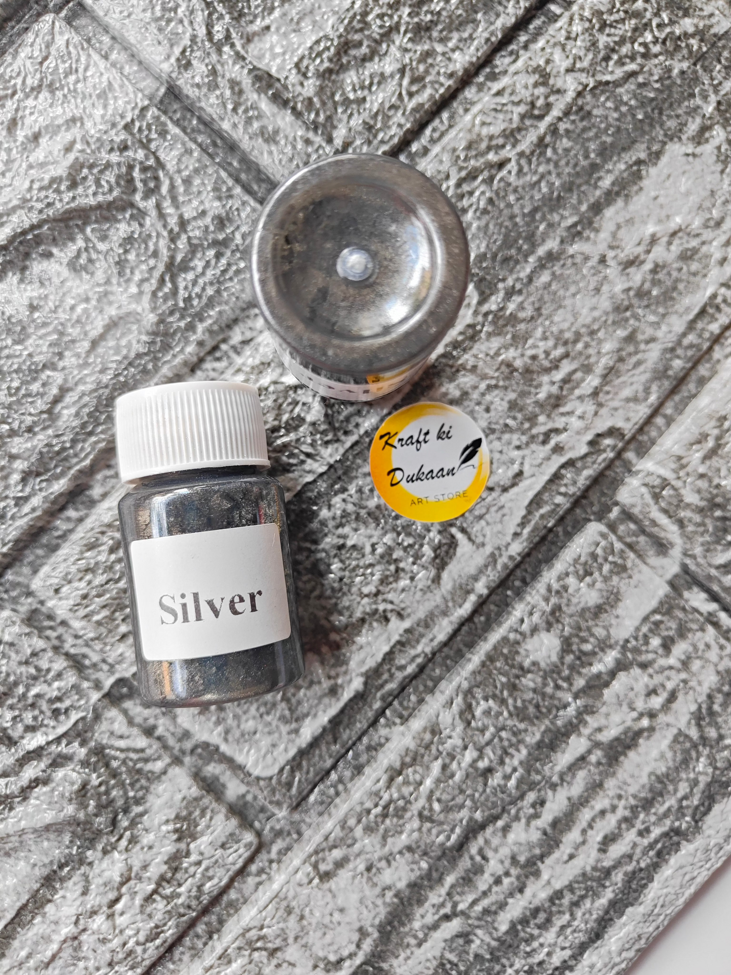 Silver mica powder for resin art in a small container by Kraft ki Dukaan for crafting projects