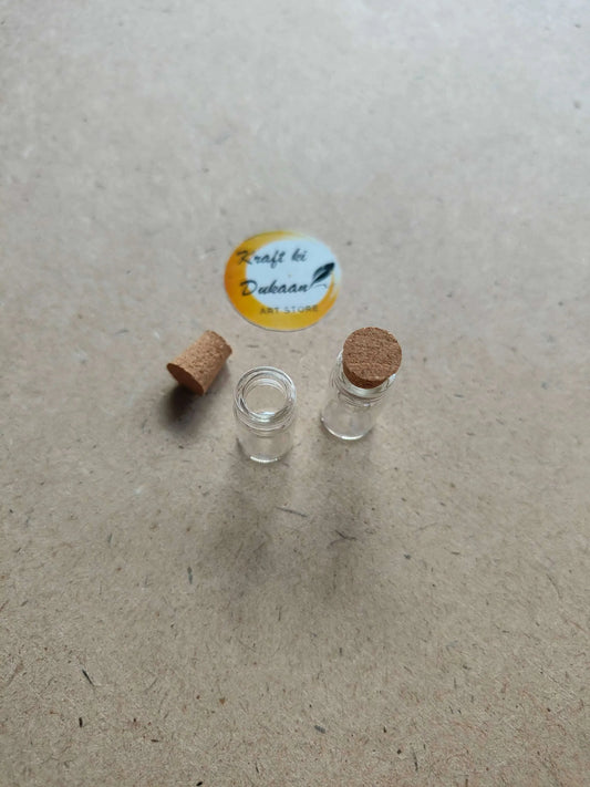 Small clear glass bottles with cork stoppers and spare cork pieces