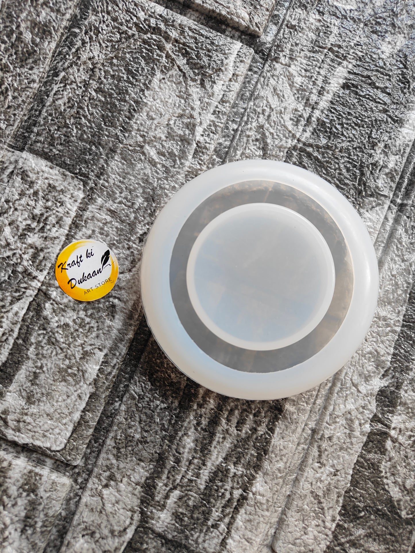 Round t-light holder mould placed on textured stone surface by Kraft ki Dukaan