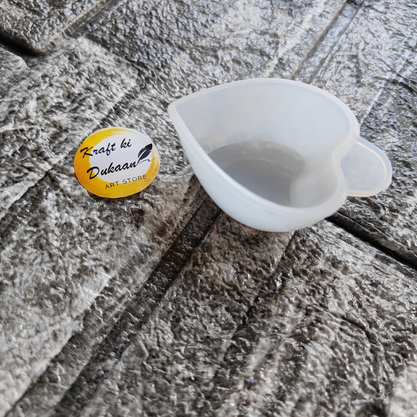 Kraft ki Dukaan small mixing cup for art made of translucent silicone on textured surface