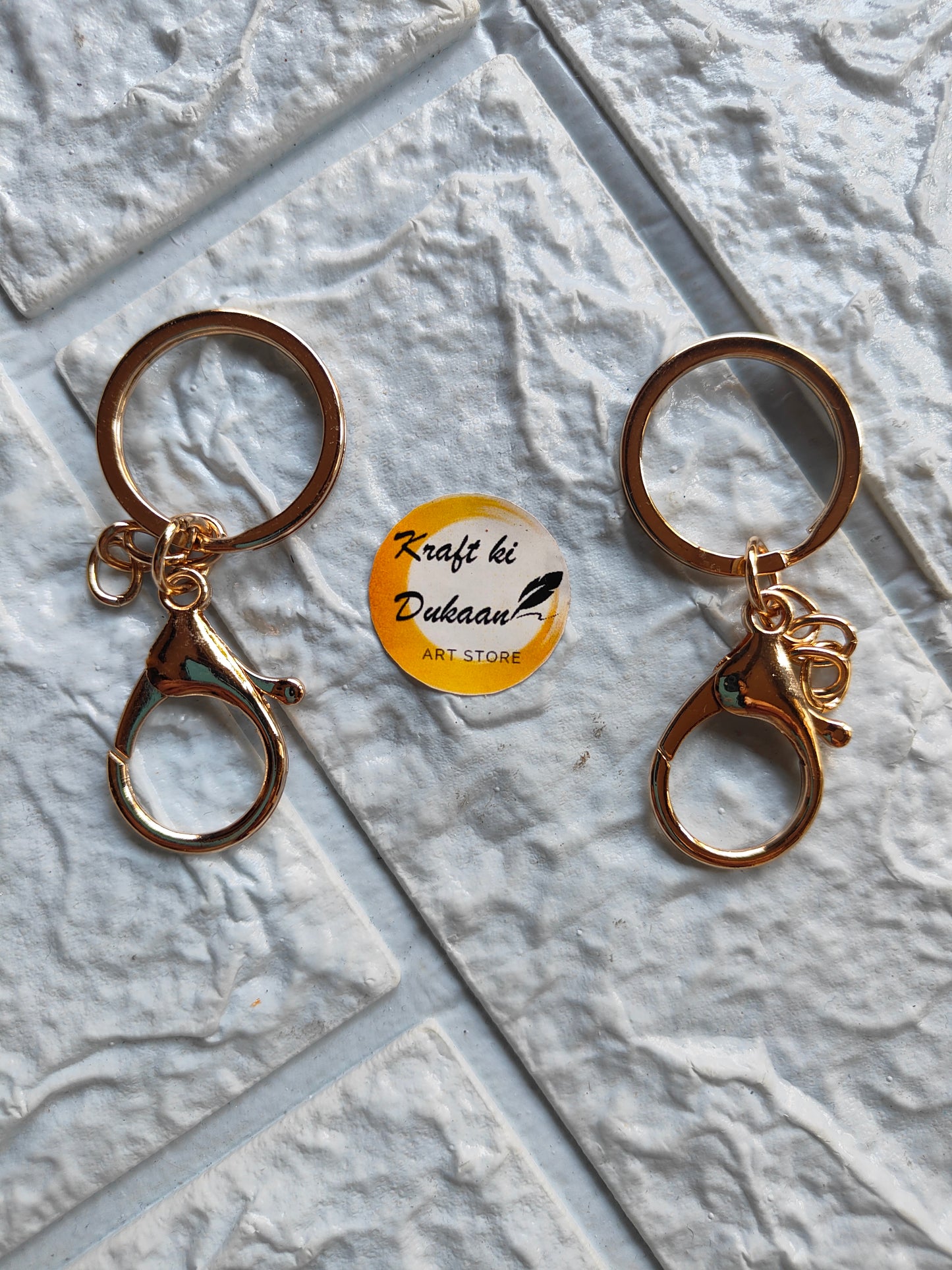 Set of two gold lobster clasp keychains with circular rings for practical use