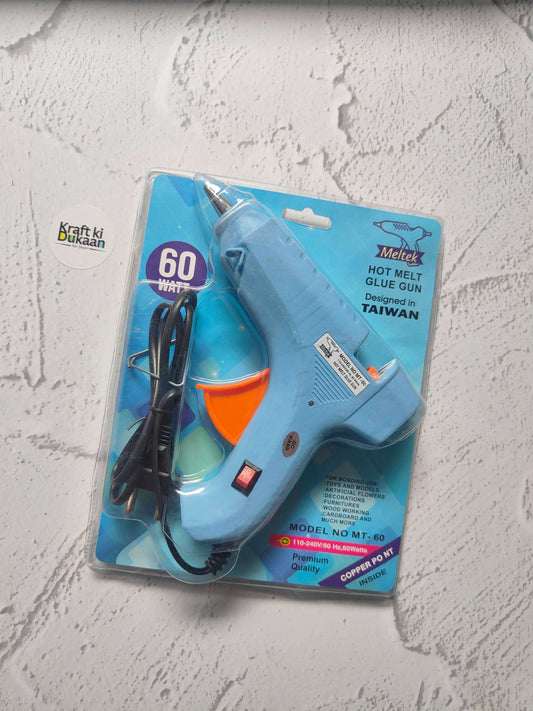 Hot melt glue gun blister pack, blue body with orange front and black power cord.