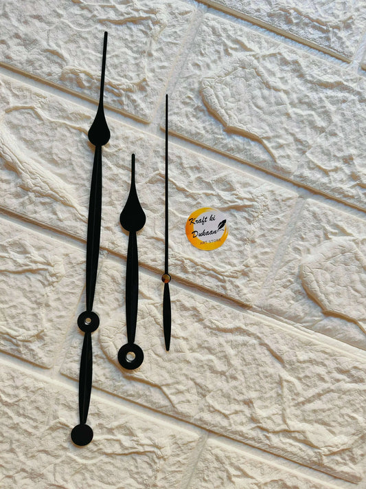 Black metal clock hands with teardrop tips and round face plates