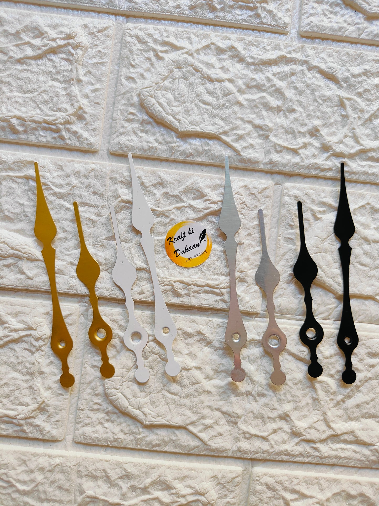 Set of metal clock hands for crafts in gold, silver, and black for DIY projects