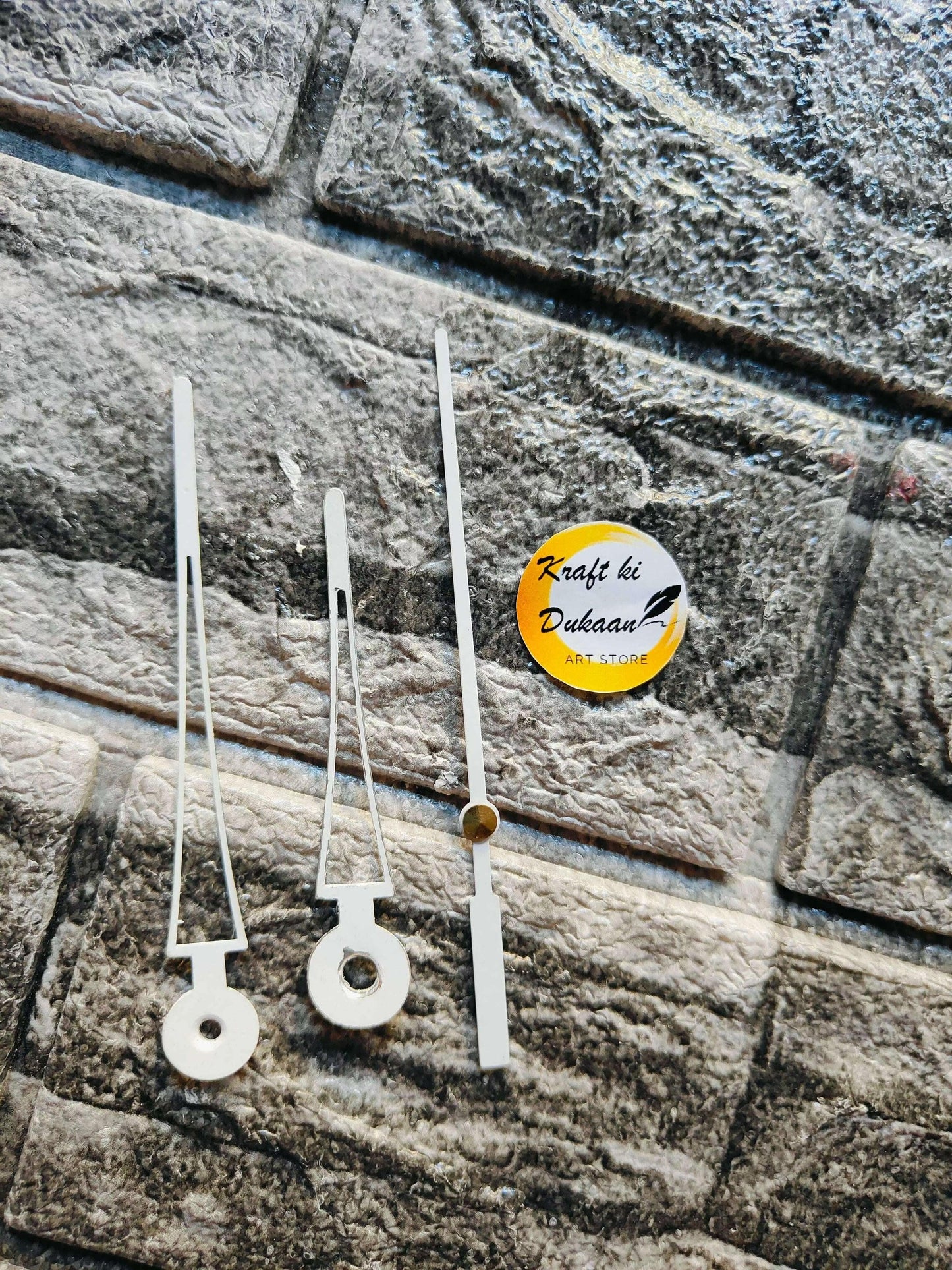 Metal clock hands set in white/silver finish, three long hands