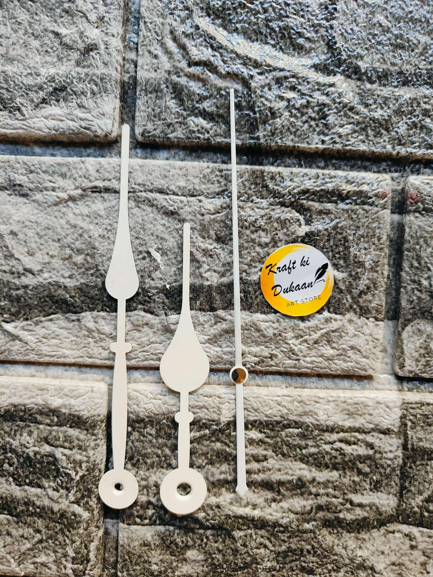 Metal clock hands set in white with slender center hands and round clock faces