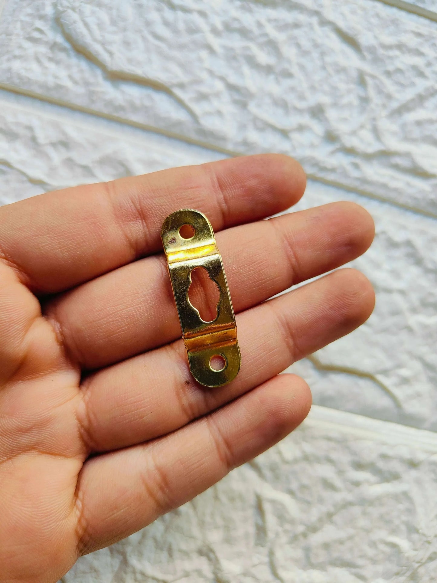 Metal Hook A2 close-up: gold-tone clasp with circular holes and cutout