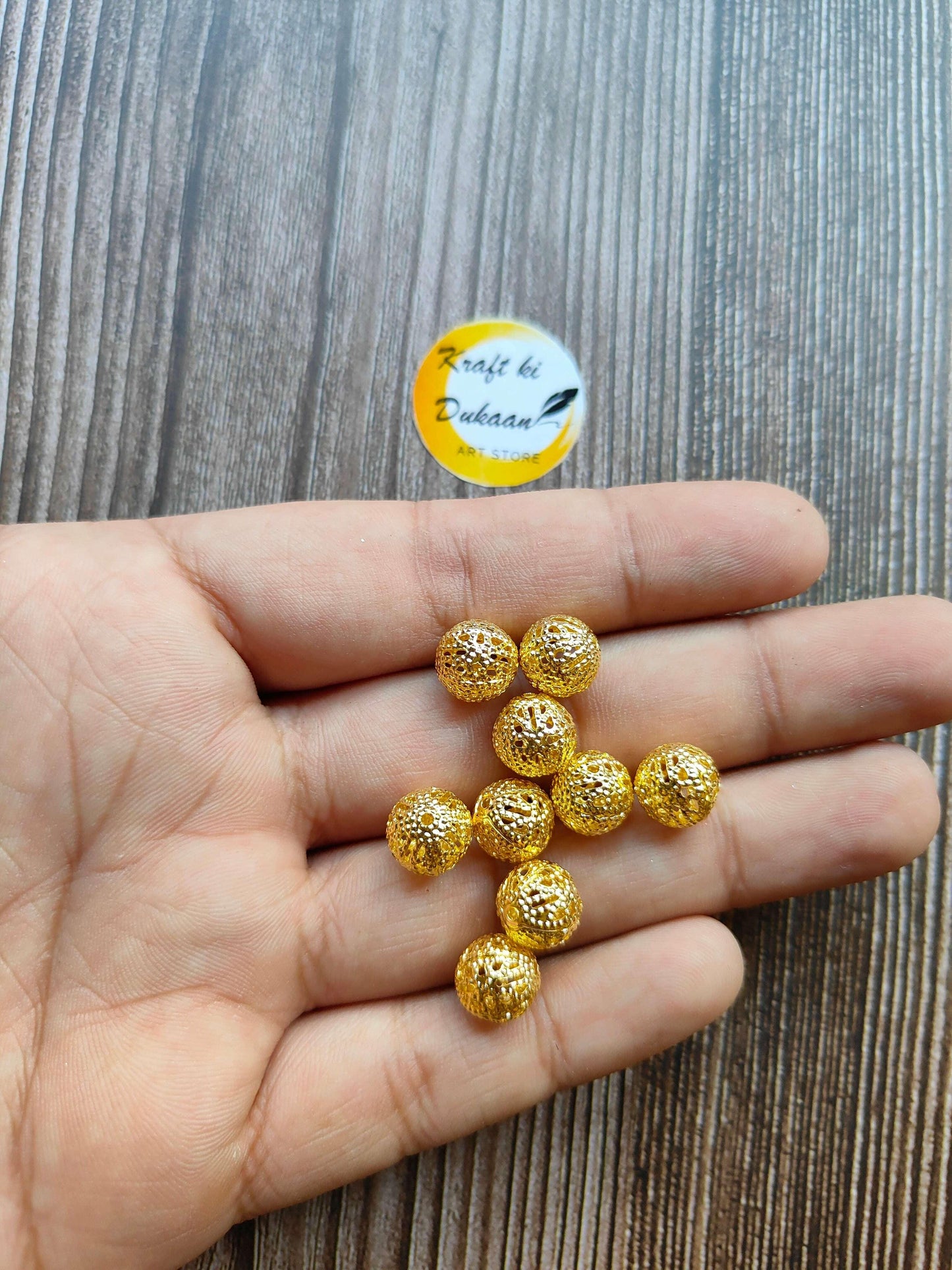 metal-jali-craft-balls-gold-bead-set-in-hand