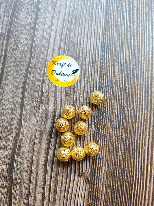 metal-jali-craft-balls-gold-bead-set-on-wood