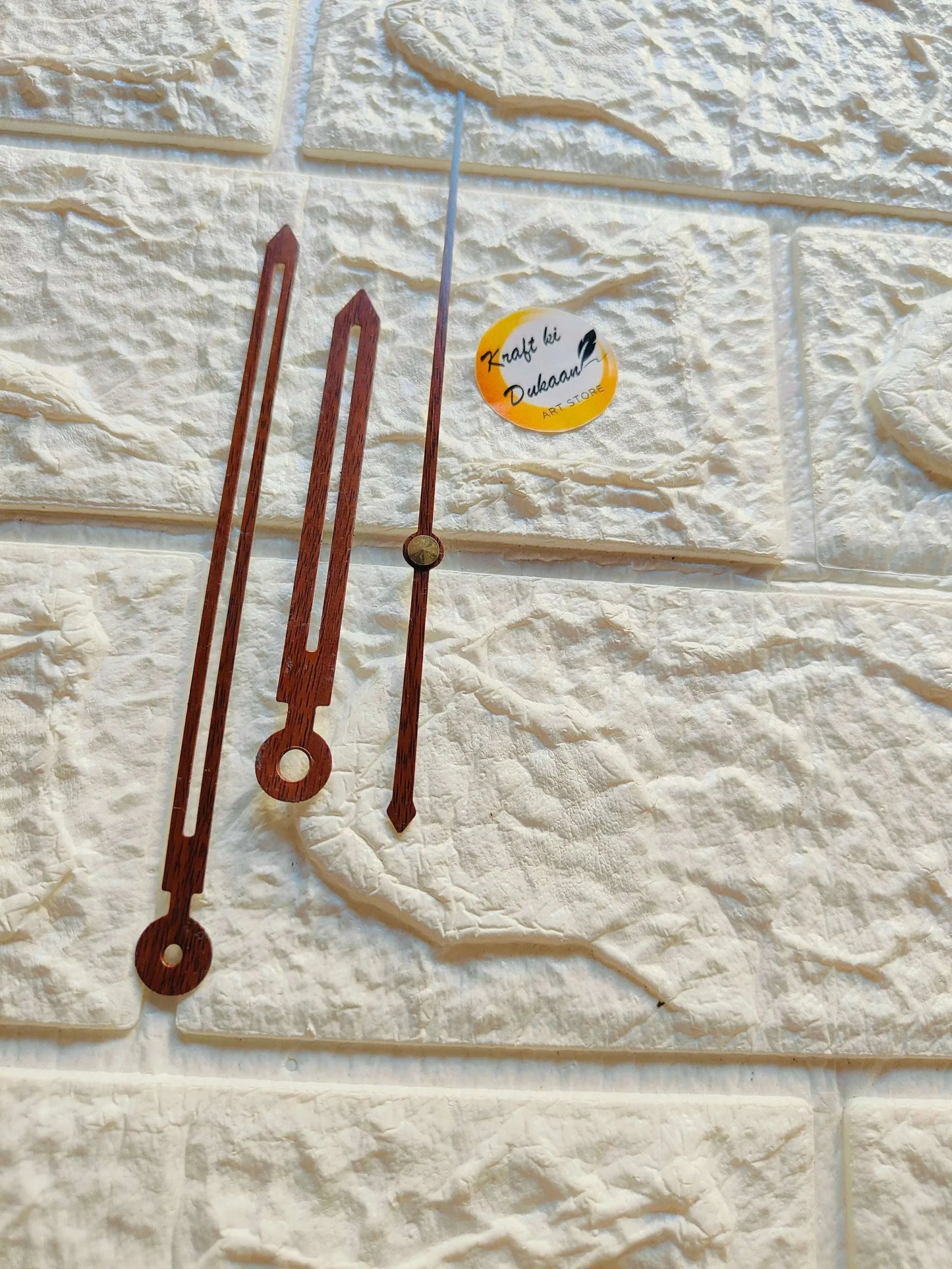 Clock hands with dark wooden metal-finish blades and round mounting ends