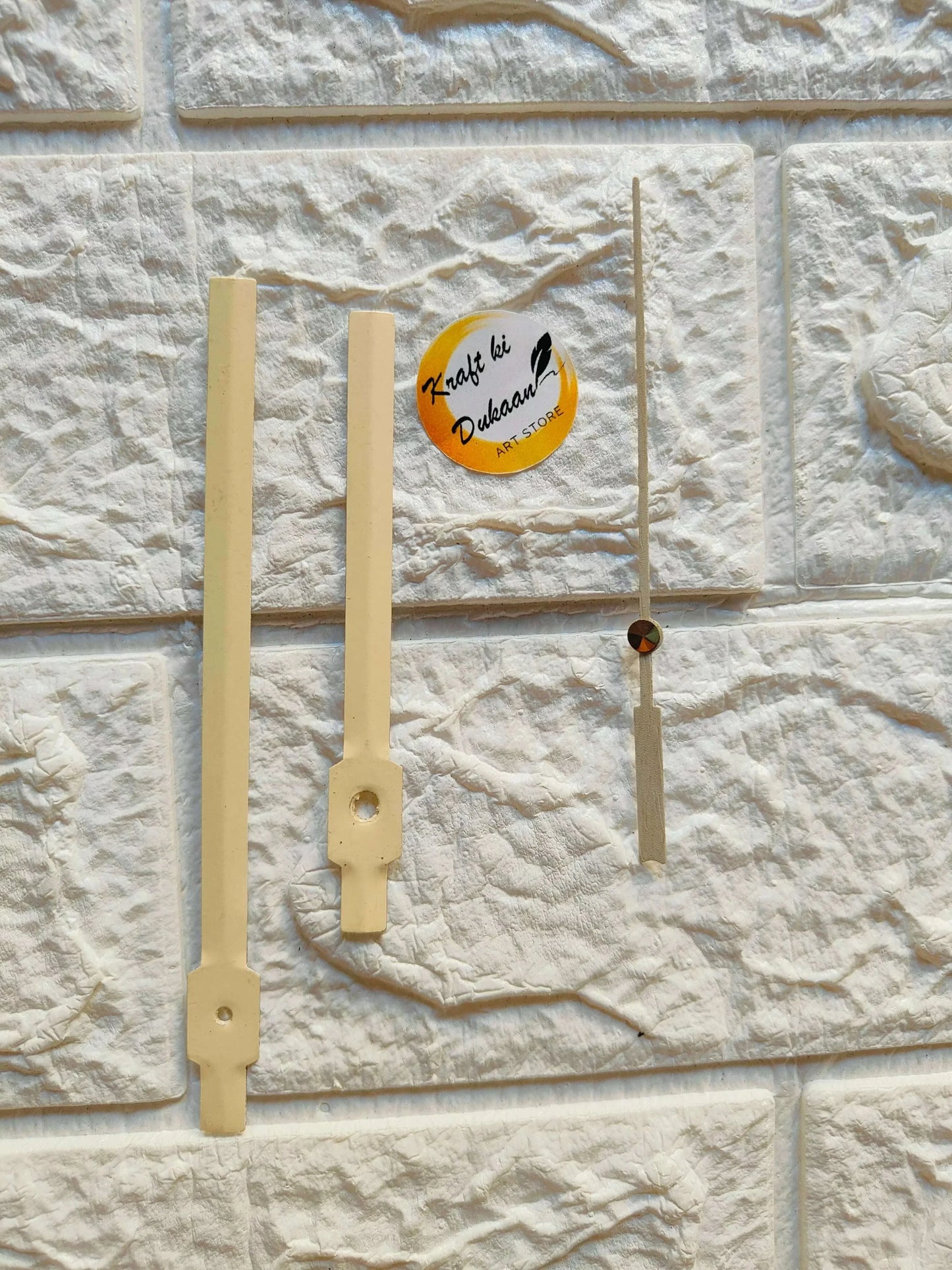 Light wooden clock hands set with metal-style center hardware
