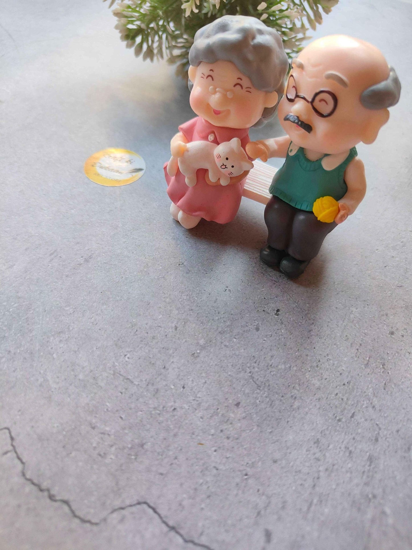 Miniature Model A27: grandmother in pink holding baby and a white teddy bear