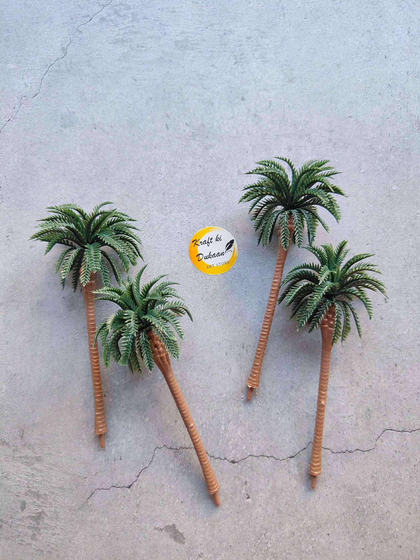 Miniature Model A29: four small palm trees with brown trunks and green fronds