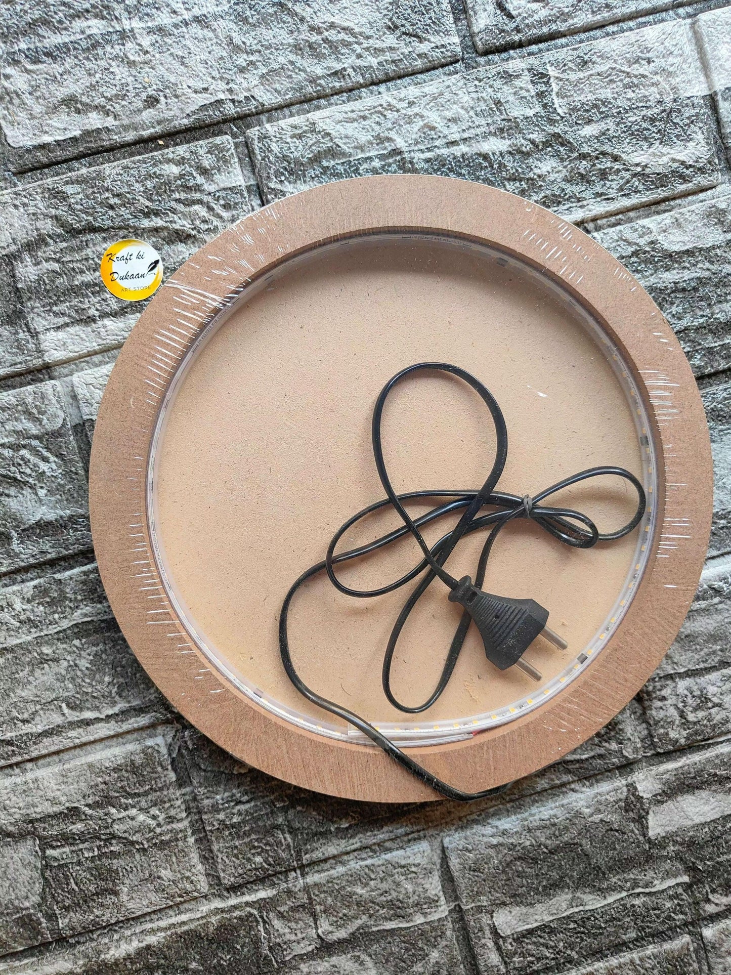 Moon LED lamp board with black power cord and plug on clear ring inside MDF frame