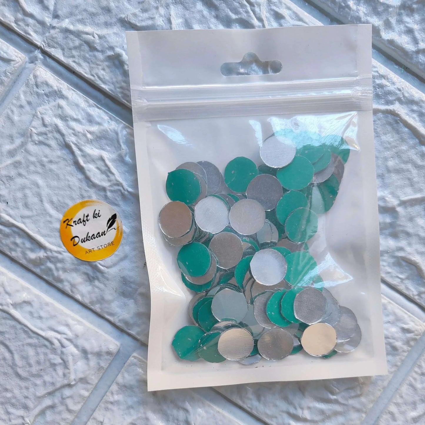 A2 circular mirror mosaic tiles in sealed bag: teal, silver, and light beige/white.