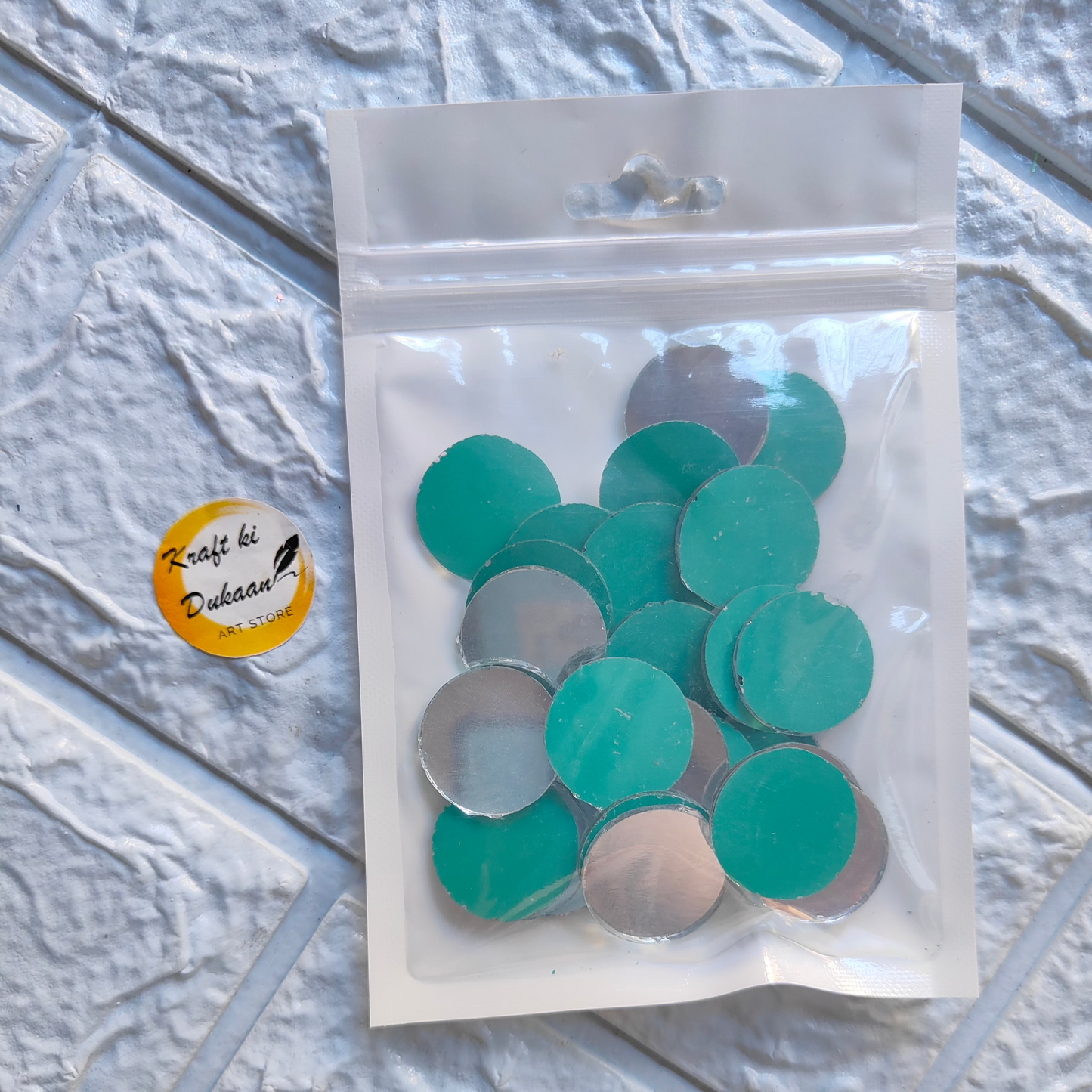Mirror mosaic craft supplies in clear bag featuring colorful round pieces for creative projects