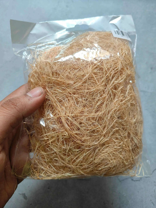 Thin natural grass in clear bag, tan straw fibers held in hand