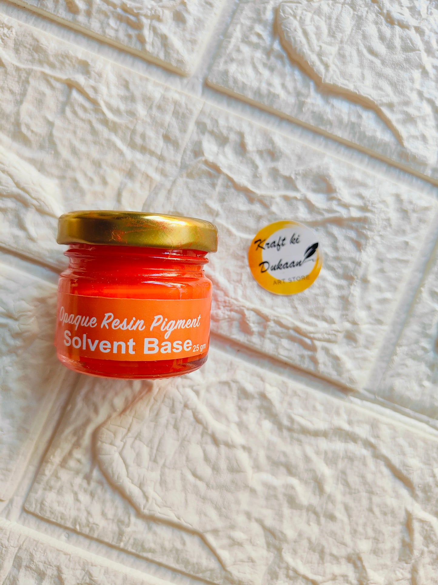 Opaque pigment for resin in vibrant red color contained in a small jar with gold lid