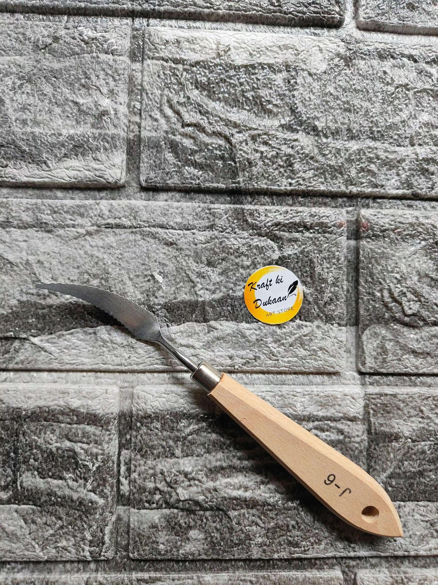 Painting knife with wooden handle and metal blade tip