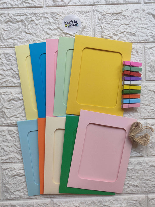 Colorful hanging photo frames set with square windows, twine and mini clips