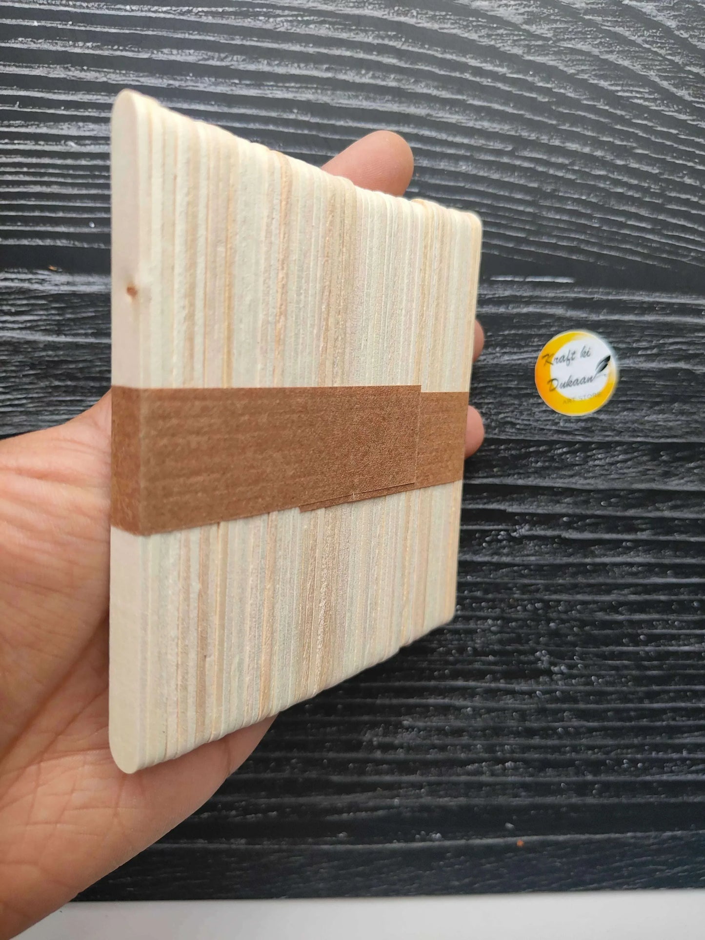 Small plain ice cream stick bundle, side view with kraft paper band