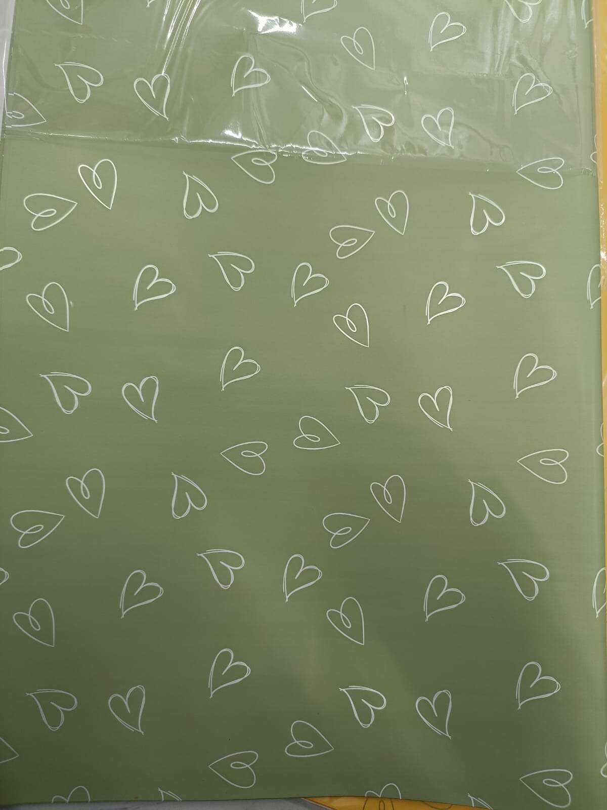 Wrapping paper plastic W5, green sheet with white heart outlines, 59x57 cm