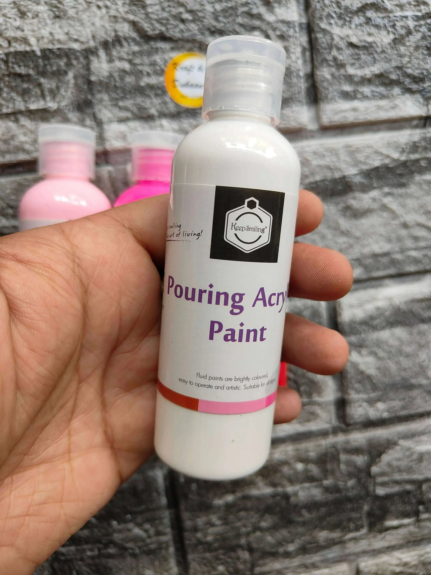 White pouring acrylic paint bottle with 'Pouring Acrylic Paint' label and clear cap