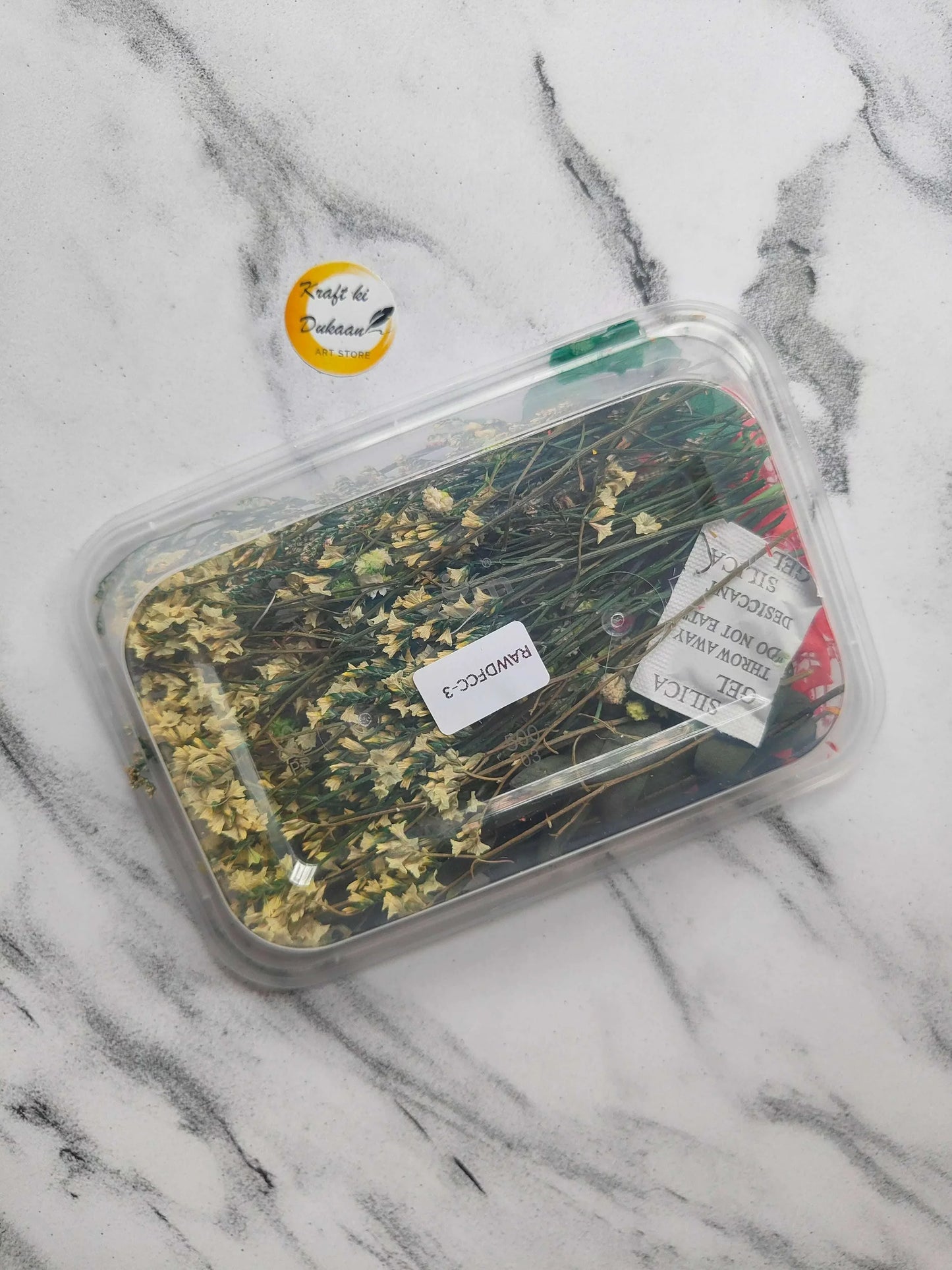 Dry flower box E7 with yellow-green dried flowers in clear plastic container