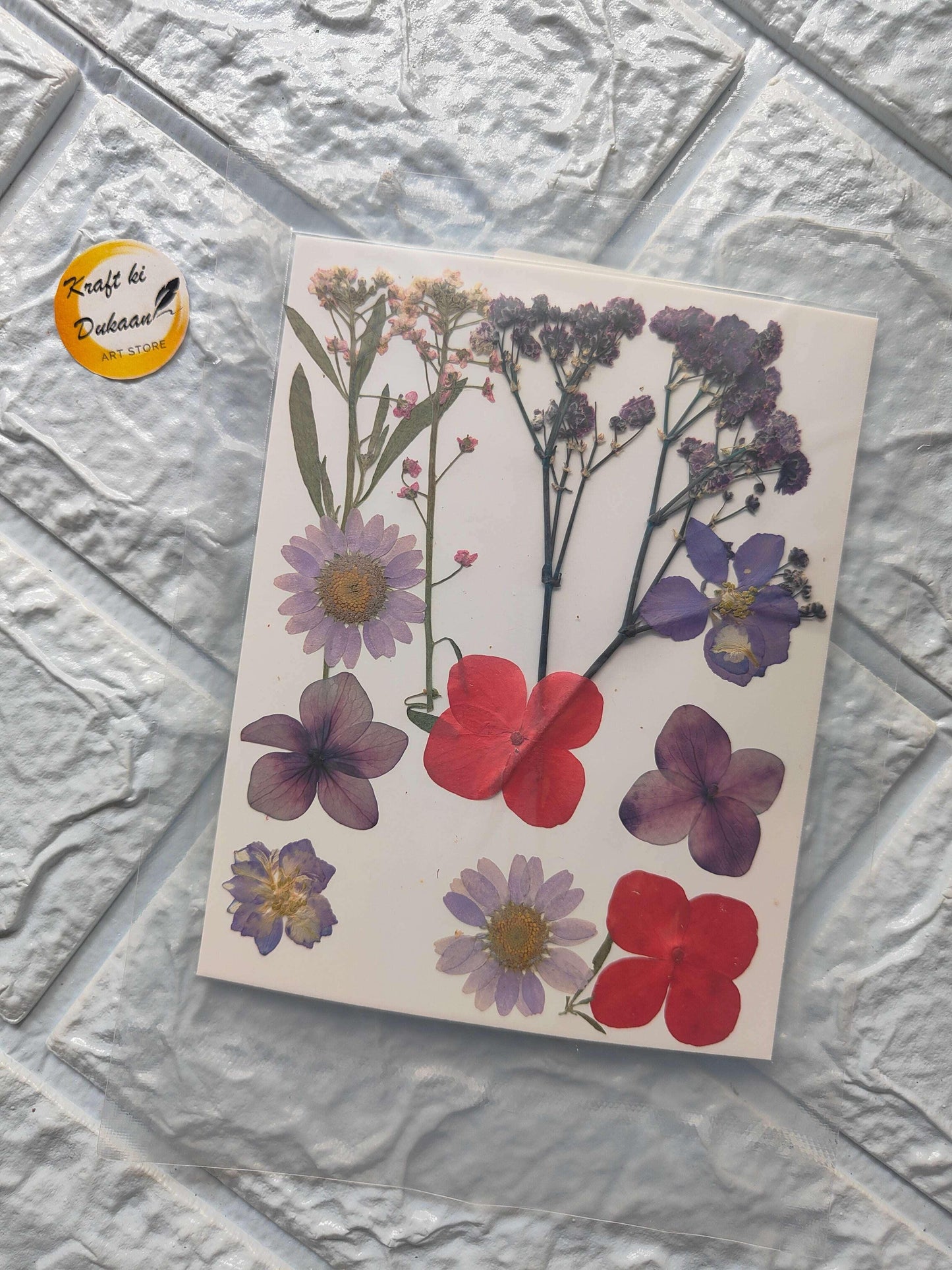 Pressed Flower Sheet Mix A16 with purple and red dried flower shapes on paper
