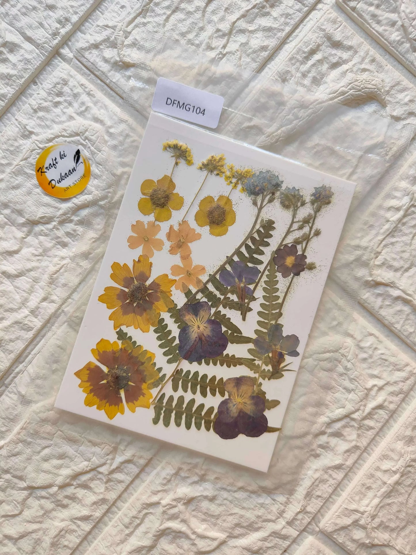 Pressed Flower Sheet Mix B29 with yellow and purple pressed blossoms on a white sheet